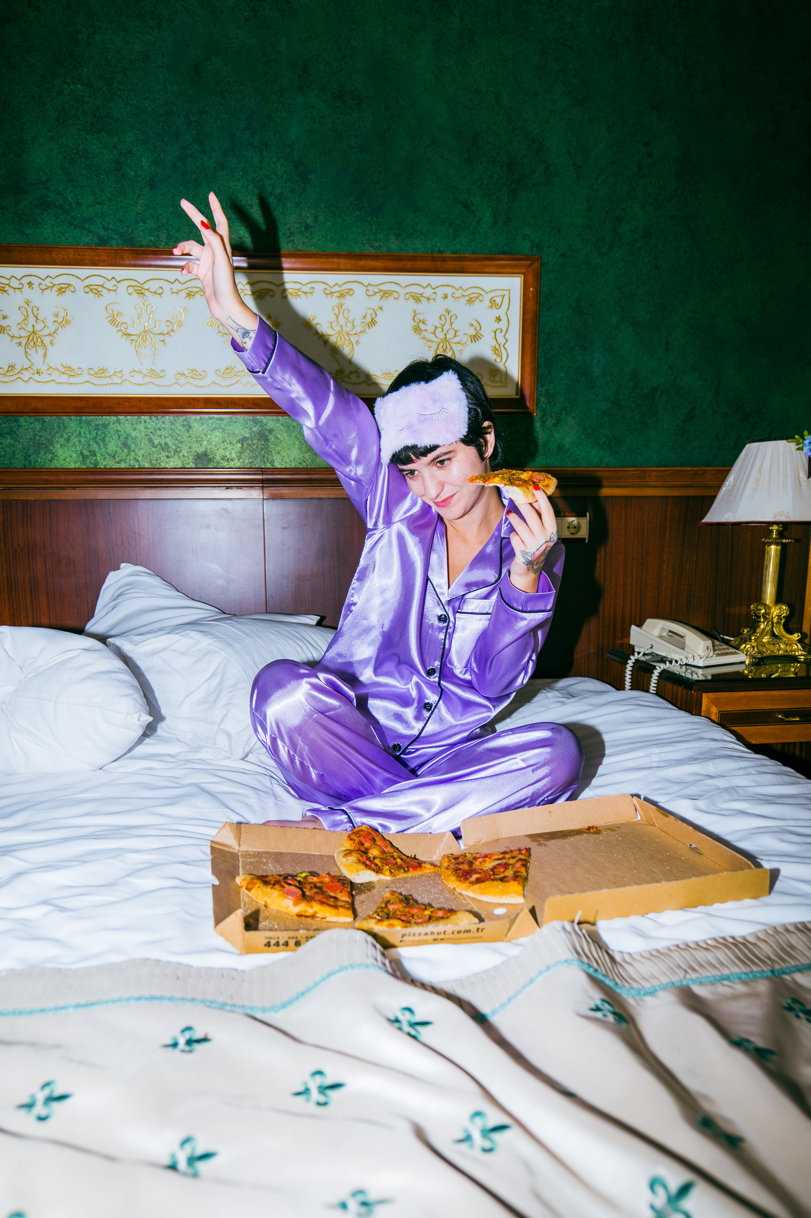 Queer Person Eating Pizza at a Slumber Party